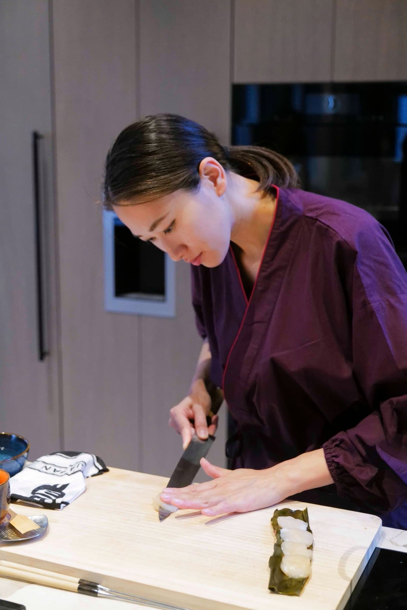 The chef shaping nigiri at the counter